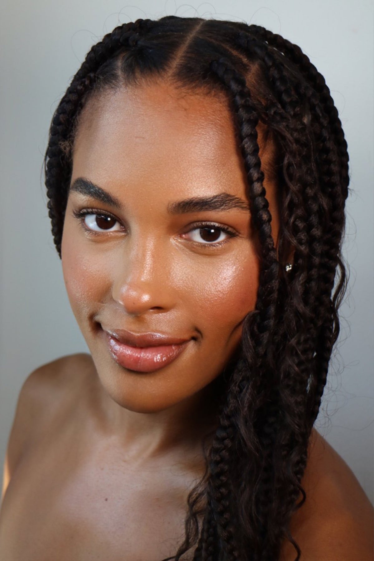 Black woman with luminous, natural-looking skin wearing a soft, minimal makeup look